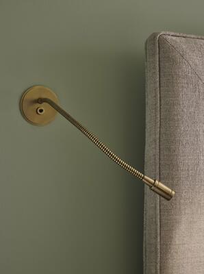 Available in brass or bronze, the sleek, flexible arm of the Midhurst reading light includes an integrated LED bulb