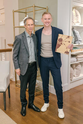 Rizzoli’s Charles Miers and Josh Young, holding a copy of his new book, "Artful Home," featuring an exclusive cover by Williams Sonoma Home