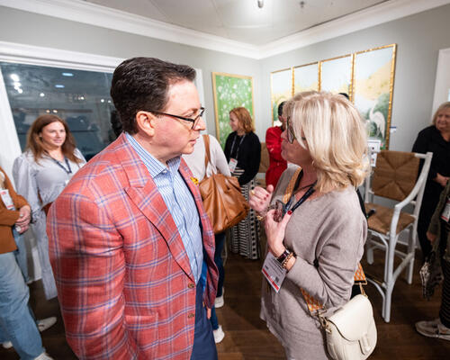 Dennis Scully chatting with a guest following the panel discussion