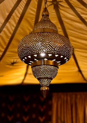 Complementary Moroccan light fixtures gave the space a relaxed, moody feel. (Image courtesy of Bernhardt)