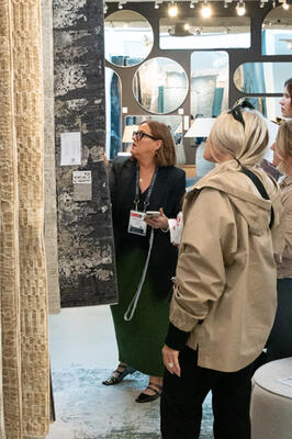 Guests browsing through rugs before the event