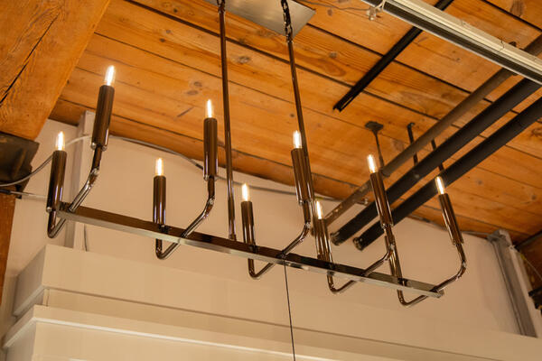 A new Carbonia chandelier from Mavisten Edition and Robert Abbey is shown in Black Chrome