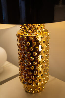 The Dolly table lamp from the Custom collection, shows in polished gold glazed ceramic