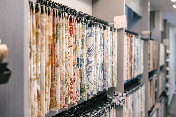 Textile samples adorn racks in the new Kravet Workspace