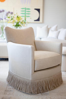 The Dibs swivel chair, now available with fringe