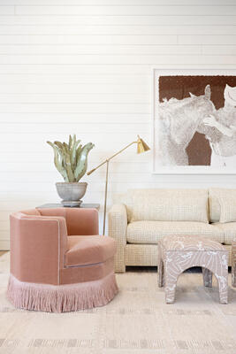 Tonal fringe on the Ivy swivel chair elevates any space