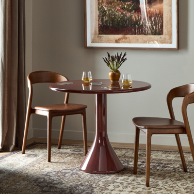 Add a pop of color with the concrete, bistro-style Vernon dining table finished in a rich, glossy red