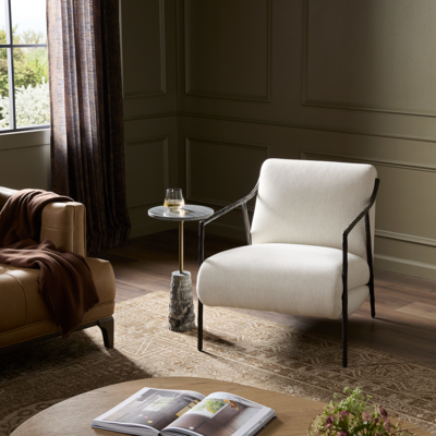 Deco-inspired, with a hammered iron frame, sloped metal arms and tapered legs, the Cassidy chair is upholstered in high-performance Crypton fabric