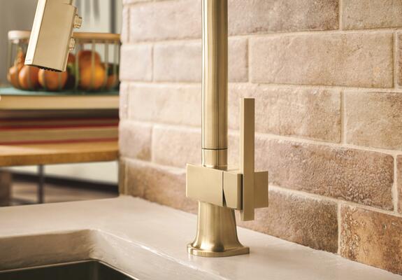 Pull-down kitchen faucet with offset lever handle in Brilliance Luxe Gold