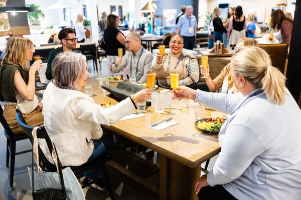 Designers enjoy a toast while connecting with the Four Hands team