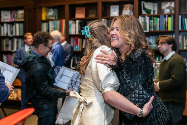 Kendall Wilkinson (right) greets a guest