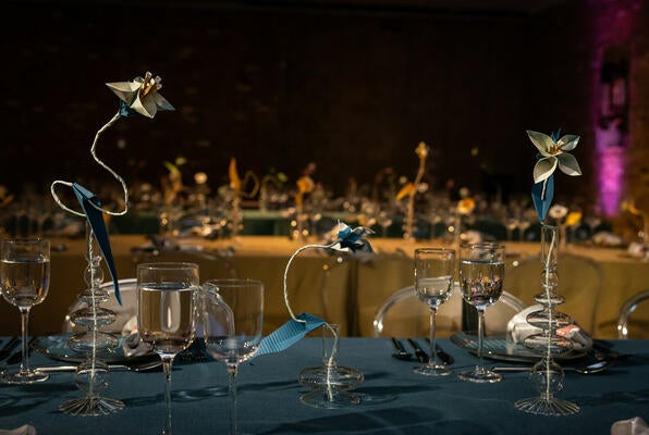 Created by Talo Kawasaki, origami flowers crafted from Kravet’s wallcoverings adorned the tables