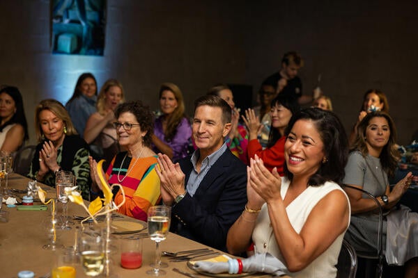 Guests applaud a warm welcome from Cary Kravet