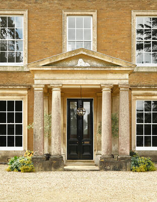 Salton globe lantern: Hand-fabricated brass with a lacquered bronze finish and handblown glass