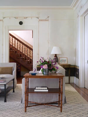 Turned bamboo legs and an X-stretcher support two rectangular shelves on the new Bamboo side table