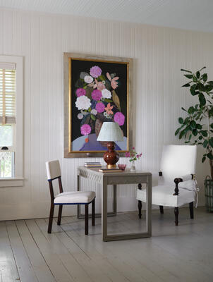 A trellis motif decorates the apron of the new Lattice desk, paired here with the Sebastian chair