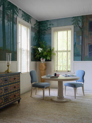 The Belvedere dining table pairs a classic fluted column base with a round top