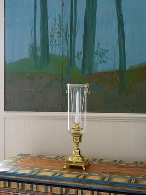 The Adonis hurricane elevates the classic taper candle with a slim profile and tall glass shade