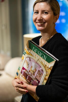 Morgan Pearce with her copy of “Design Reimagined”