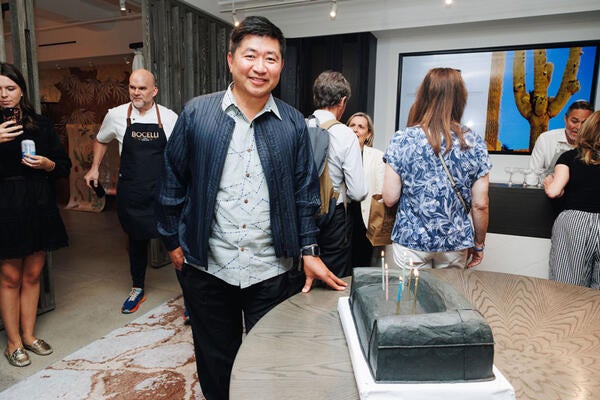 In celebration of his firm’s 25th anniversary, Jiun Ho poses with a cake in  the shape of his iconic Colina sofa