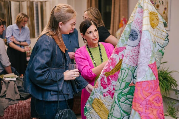 Michal Silver shows off one of the 25th anniversary quilts