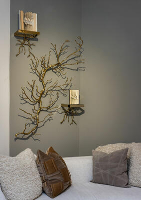 Shelves accented by a gilded branch decorated the walls 