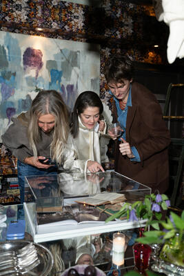 Kim Lambert, Clarisa Llaneza and Nolan Bryant view the Elise de Wolfe display