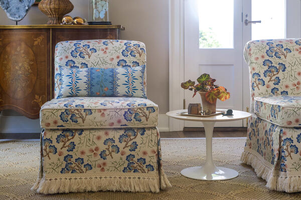 Slipper chair upholstered in Nikko Terracotta Blue Haze with coordinating throw pillow in Chandler   in the same colorway