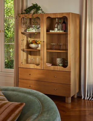 With shapely glass panels, the Jordena curio cabinet offers a polished take on storage and display