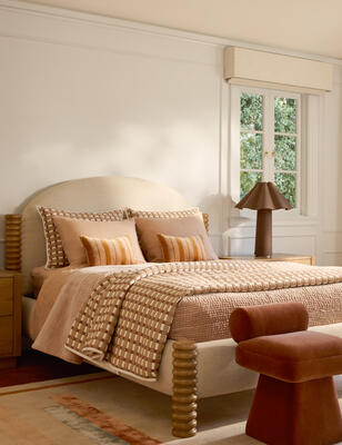 An arched headboard and turned wood legs give the Morello bed a playful yet sophisticated presence