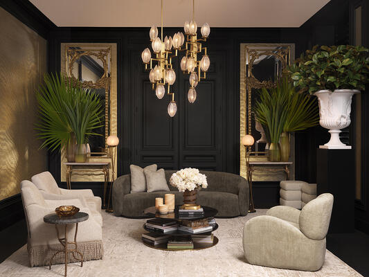 Chandelier Persephone: A framework of angular brass arms ascends and descends in rhythmic precision