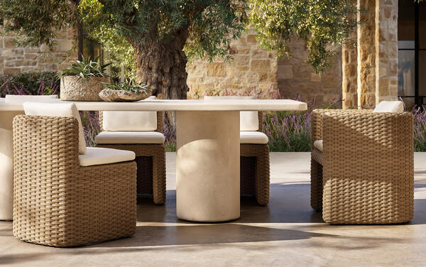 Bastien dining collection in all-weather wicker shown with the Terzo dining table
