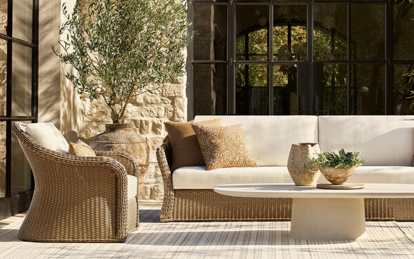 Amelie collection in all-weather wicker shown with the Caprera coffee table