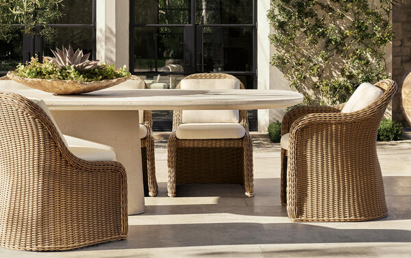 Amelie dining collection in all-weather wicker shown with the Caprera dining table