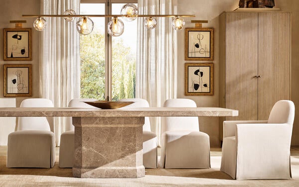 Antic dining table in emperador marble shown with Monastère dining side chairs