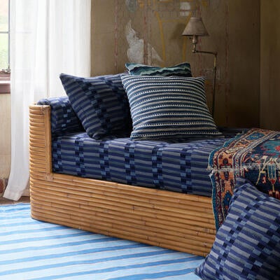 The palette is grounded and earthy—ochers, warm clays and deep neutrals