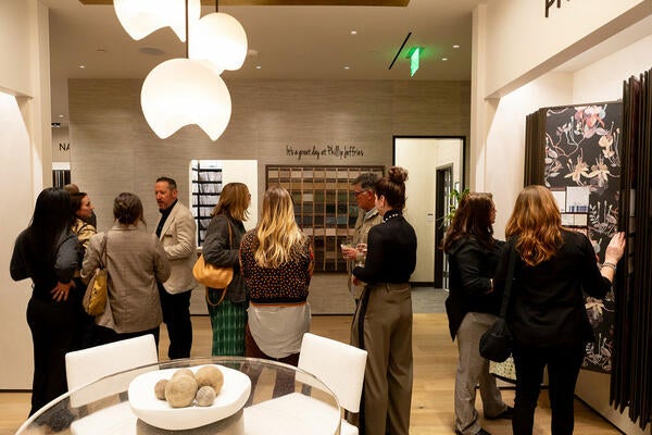 Guests mingling inside Phillip Jeffries’s new Denver Design District showroom