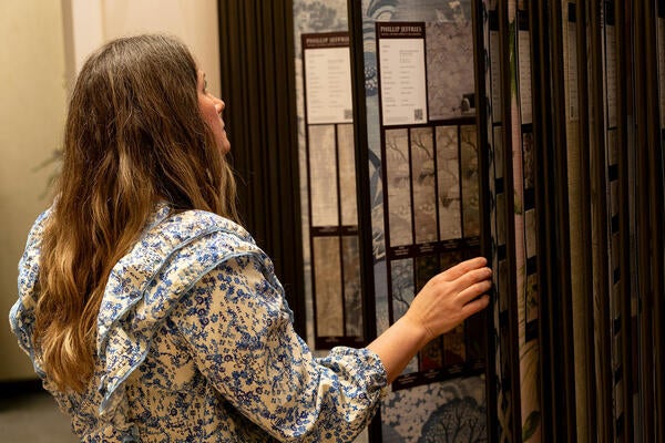 A guest peruses the wallpaper options on display