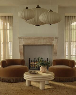 Lenny swivel chairs paired with Brittny coffee table and a cluster of Plaza pendants