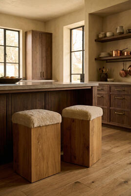 Antwerp counter stools top a French oak base with New Zealand shearling; footrest included on front