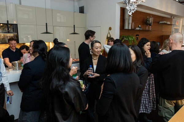 Lynn Juang mingles with other guests following the panel conversation