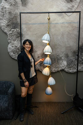 Felicia Hwang with her handcrafted Bloom Garland light inside the West | Out East showroom in New York, the site of the launch celebration for her latest collection