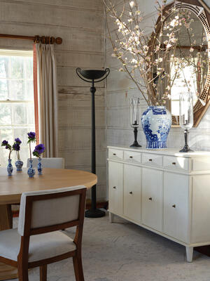 The Torch floor lamp casts its light upward, illuminating corners without exposing bulbs