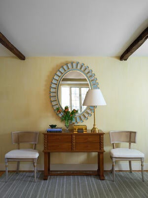 Radiating petals of icy blue lacquer give the Icarus mirror a sculptural presence