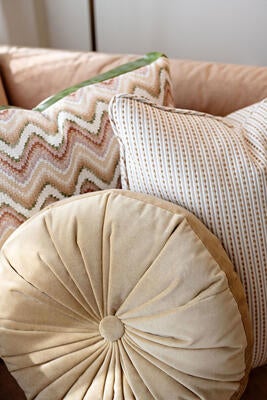 New round tufted pillows, available in most fabrics as well as COM
