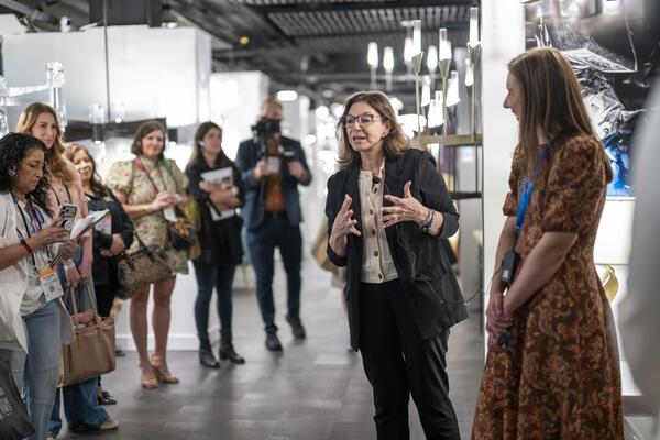 Maria Mullen, CEO of Hubbardton Forge, welcomes tour attendees to the brand’s showroom