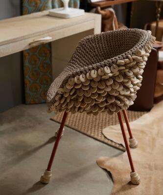 Watusi Cream cowhide console table and Chobe crocheted-leather chair