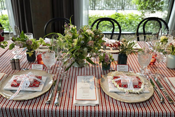 The tablescape featured a custom red ticking stripe designed by Barrie Benson and the Highland House team; spring florals of hellebores, peonies and fritillarias by Proper Flower; and Ginori 1735 tableware provided by Rambouillet  