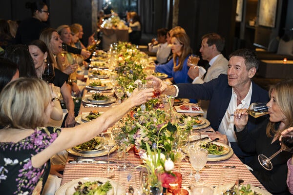 Guests say cheers to the new Highland House x Barrie Benson collection at an intimate dinner party at the Proximity Hotel