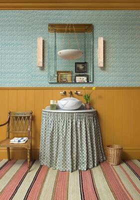 Lulworth wall light: Damp Location–rated, it softly diffuses light from bedroom to bathroom